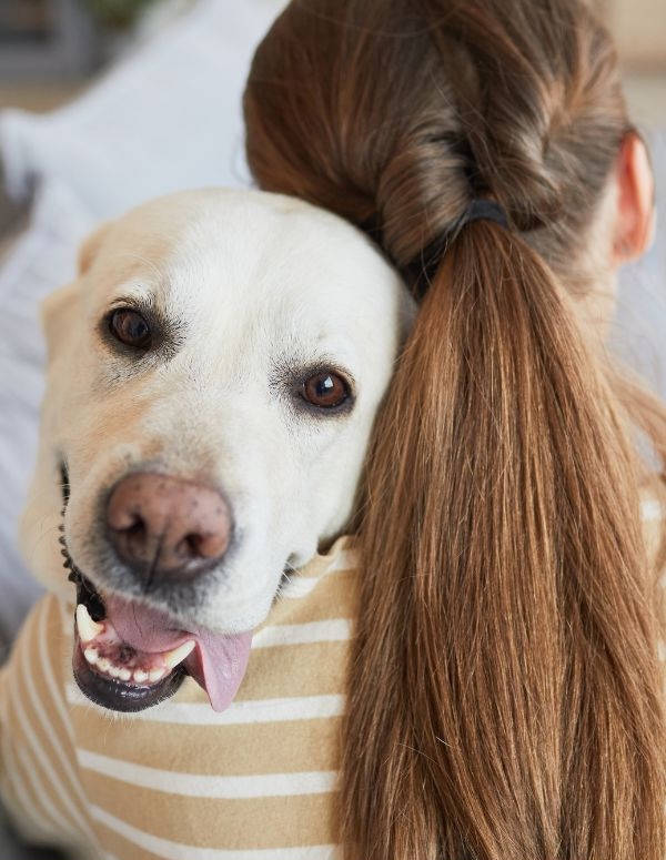 Woman hugging a large dog